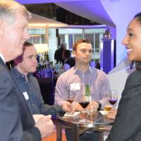 An alumna enjoys conversation with T.Haas